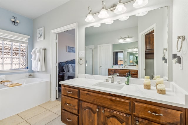 full bathroom featuring tile patterned floors, a garden tub, a stall shower, and vanity