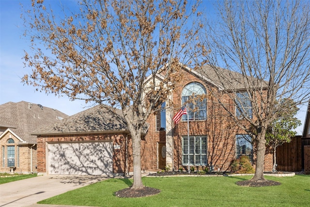 traditional-style home featuring driveway, a shingled roof, a front lawn, a garage, and brick siding