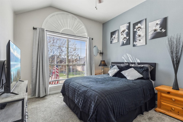 bedroom featuring vaulted ceiling, multiple windows, carpet, and baseboards