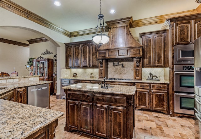 kitchen featuring stainless steel appliances, custom exhaust hood, backsplash, and crown molding