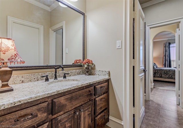 bathroom with tile patterned floors, ensuite bath, crown molding, and vanity