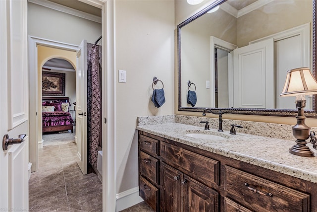 full bath with a shower with shower curtain, baseboards, crown molding, and vanity