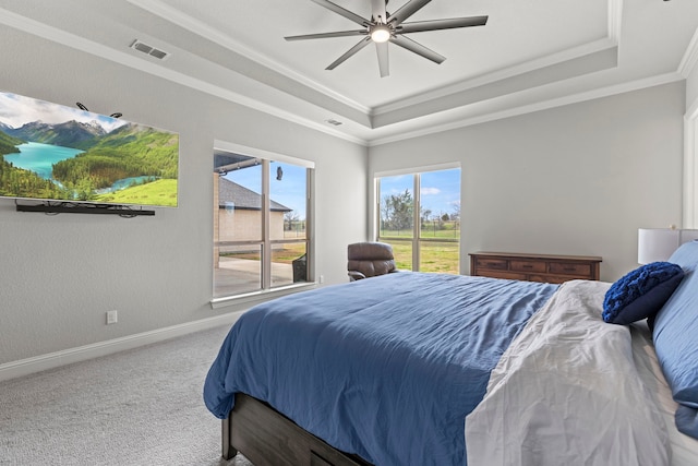 carpeted bedroom with access to outside, visible vents, baseboards, and a raised ceiling