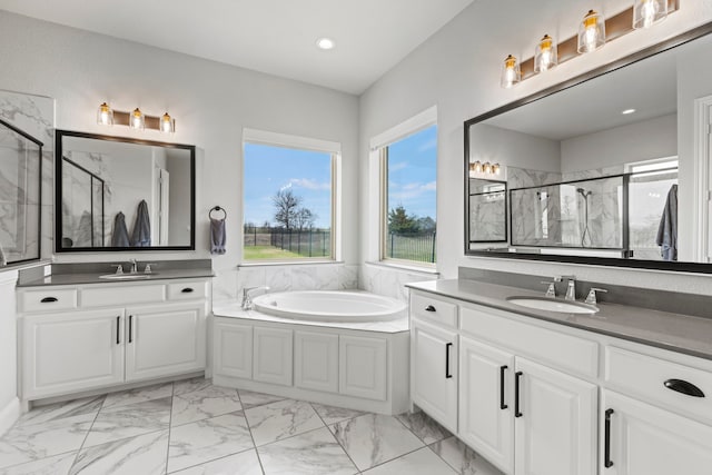 full bath featuring marble finish floor, a stall shower, and a sink