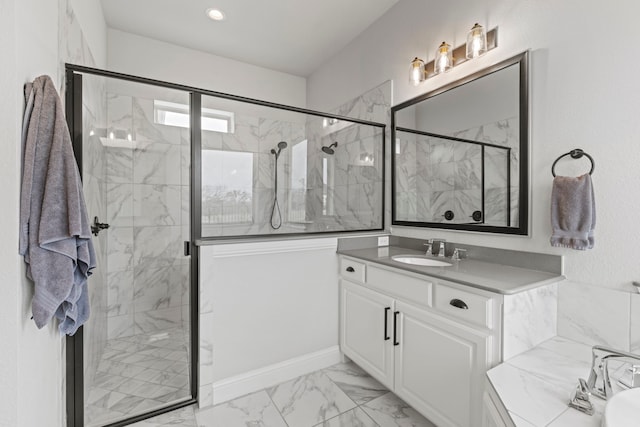 bathroom with marble finish floor, a marble finish shower, vanity, and recessed lighting