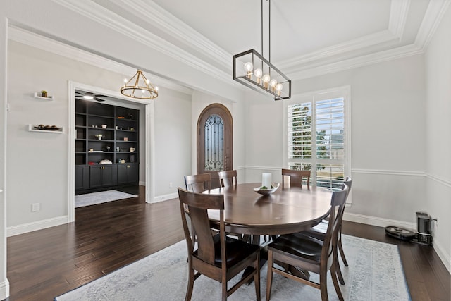 dining area featuring arched walkways, dark wood-style flooring, ornamental molding, a chandelier, and baseboards