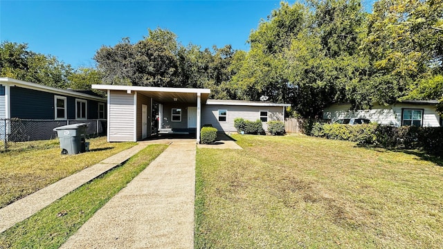 view of front of house with a front lawn and fence