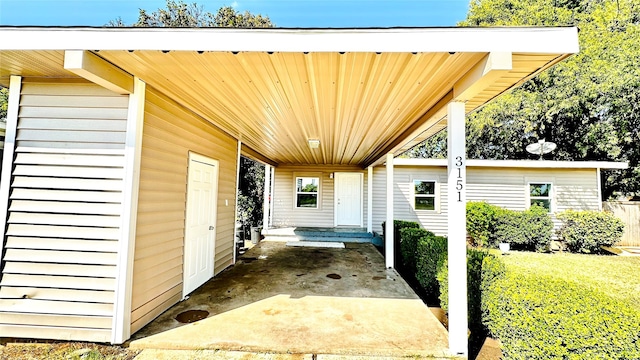 entrance to property with an attached carport