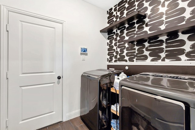 clothes washing area featuring laundry area, separate washer and dryer, and dark wood finished floors