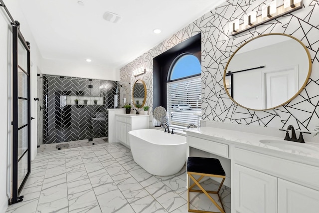 bathroom featuring recessed lighting, vanity, marble finish floor, a soaking tub, and walk in shower