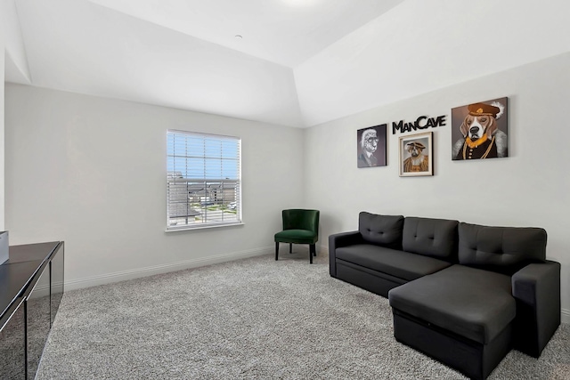 living area with vaulted ceiling, carpet, and baseboards