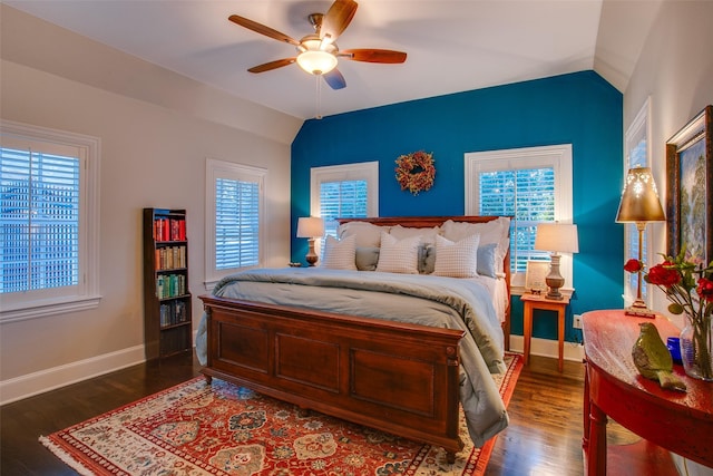 bedroom with a ceiling fan, vaulted ceiling, baseboards, and wood finished floors