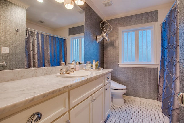 full bathroom featuring toilet, vanity, baseboards, visible vents, and crown molding