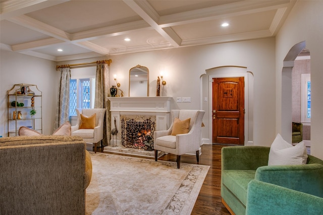 living room featuring arched walkways, coffered ceiling, beamed ceiling, dark wood-style flooring, and a high end fireplace