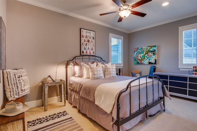 bedroom featuring multiple windows, crown molding, and light colored carpet