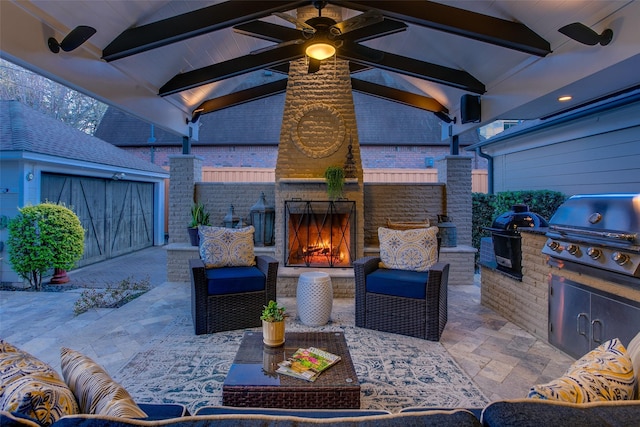 view of patio / terrace featuring a grill, an outdoor living space with a fireplace, area for grilling, and fence