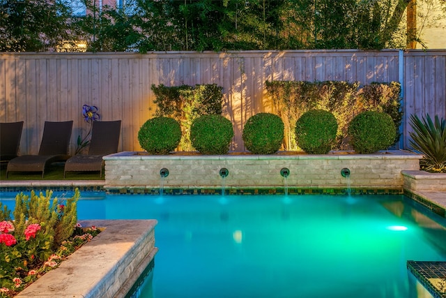 view of swimming pool with a fenced in pool and fence