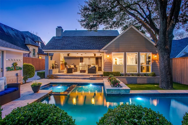 back of property with a patio area, fence, a chimney, and an outdoor hangout area