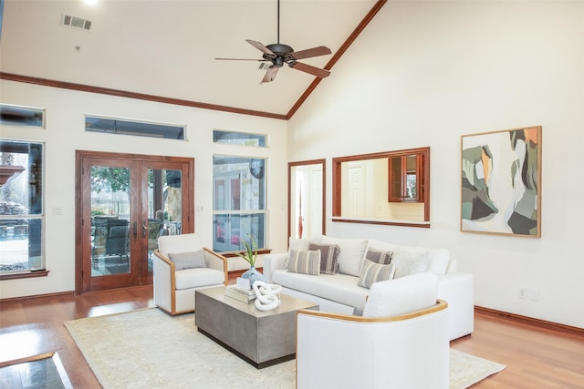 living area featuring light wood-type flooring, french doors, high vaulted ceiling, and visible vents