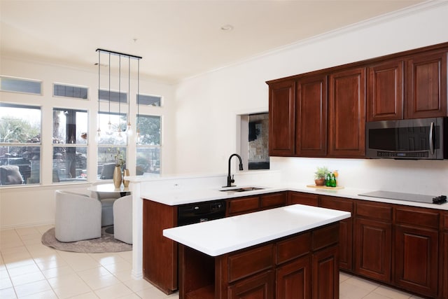 kitchen featuring crown molding, light countertops, a peninsula, black appliances, and a sink