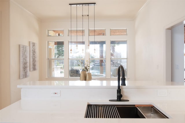 details with a sink, light countertops, decorative light fixtures, and ornamental molding