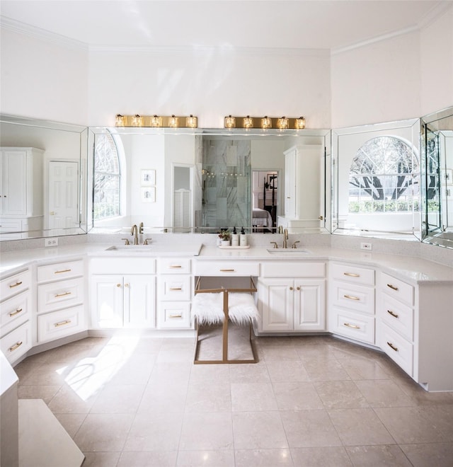 bathroom with a shower with door, tile patterned flooring, vanity, and crown molding