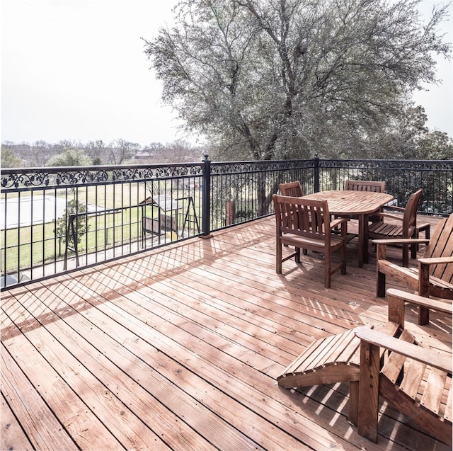 wooden deck with outdoor dining area