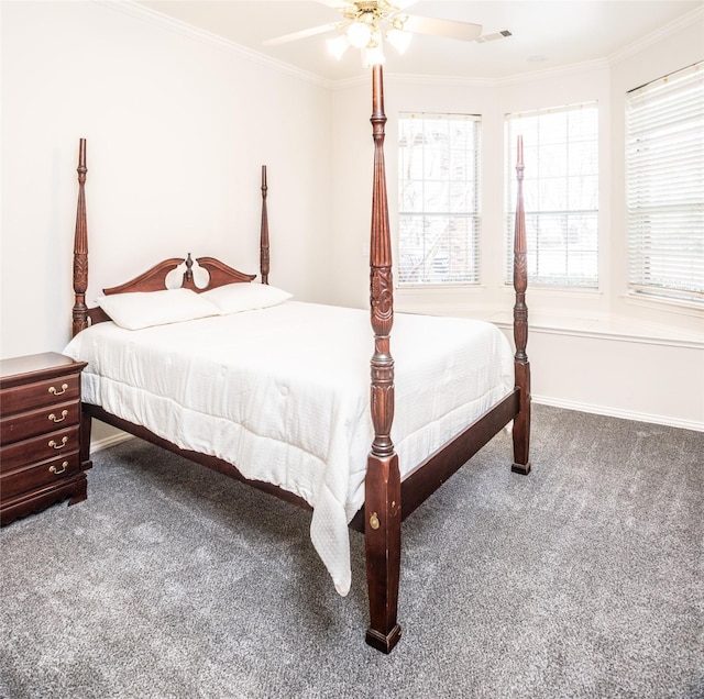 carpeted bedroom featuring visible vents, baseboards, ornamental molding, and a ceiling fan