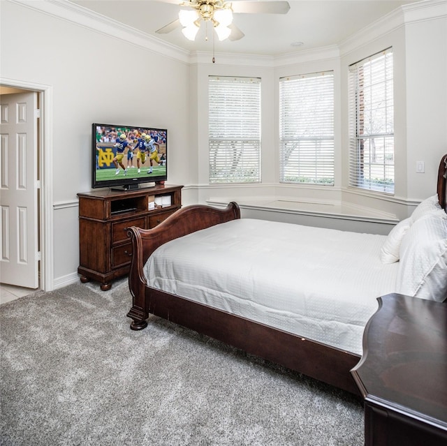 bedroom with ceiling fan, carpet floors, and ornamental molding