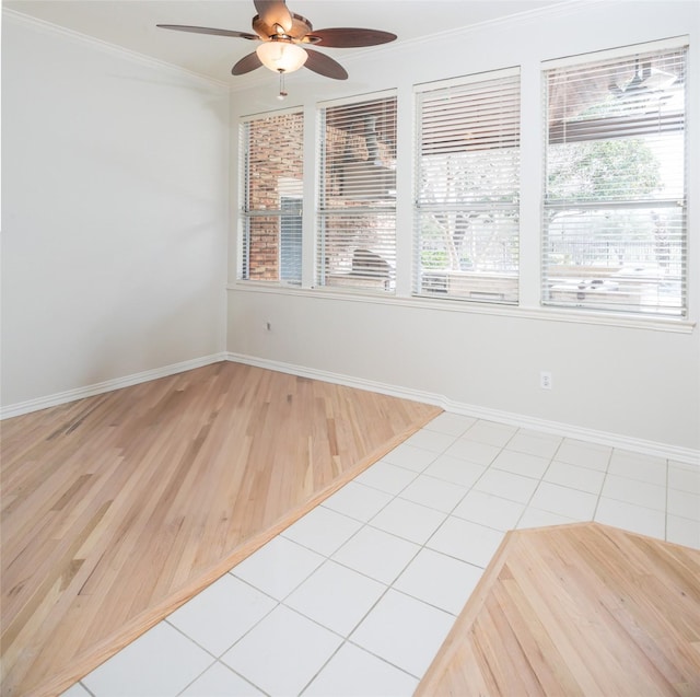 unfurnished room with ceiling fan, baseboards, ornamental molding, and light tile patterned flooring