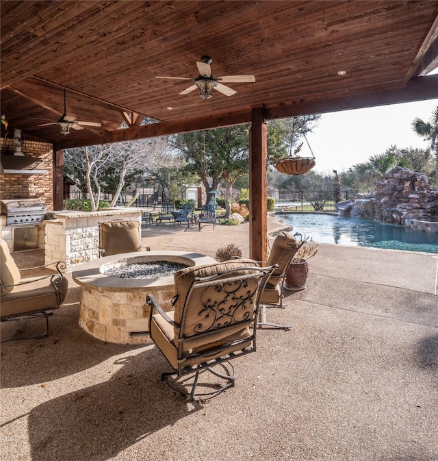 view of patio / terrace featuring an outdoor pool, a fire pit, ceiling fan, area for grilling, and a grill