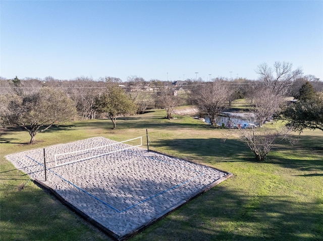 surrounding community with a lawn and volleyball court