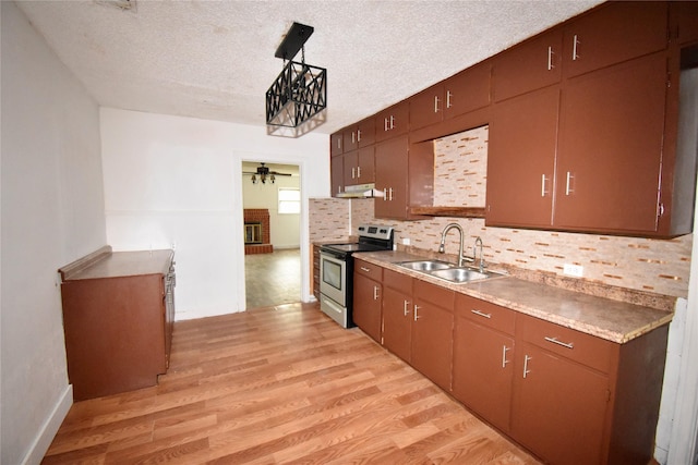 kitchen featuring light wood-style floors, a ceiling fan, stainless steel range with electric cooktop, a sink, and under cabinet range hood