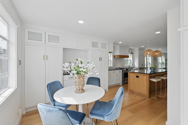 dining space featuring recessed lighting, a healthy amount of sunlight, and light wood-type flooring