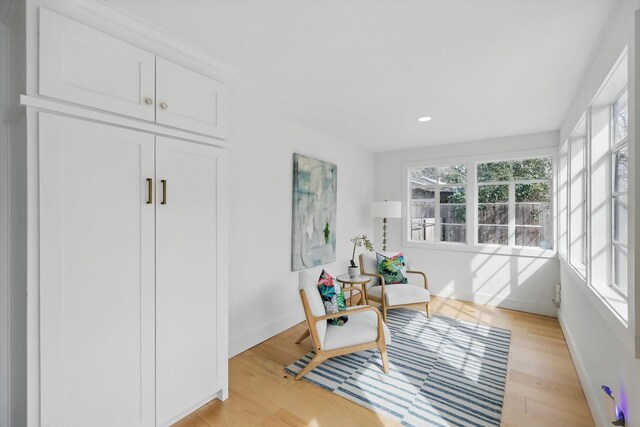 dining space featuring recessed lighting, light wood-type flooring, a brick fireplace, and visible vents