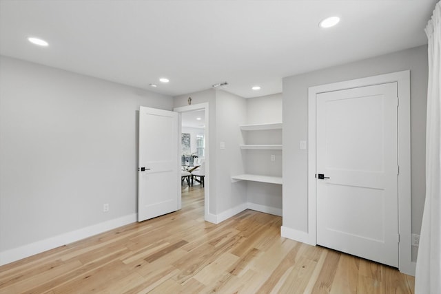 unfurnished bedroom featuring light wood-style flooring, recessed lighting, and baseboards