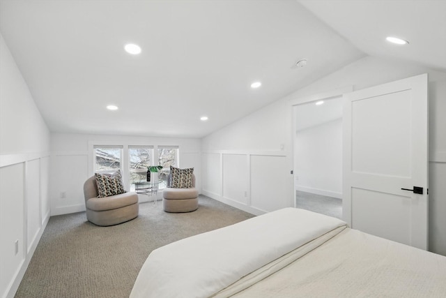 bedroom featuring recessed lighting, a decorative wall, carpet floors, and vaulted ceiling