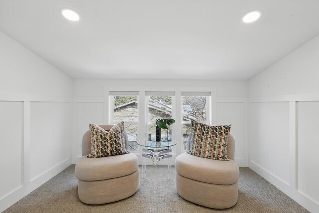 bedroom with visible vents, lofted ceiling, recessed lighting, a decorative wall, and light colored carpet