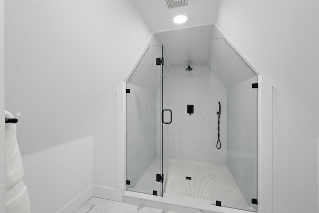 bathroom featuring visible vents, baseboards, a shower stall, vaulted ceiling, and marble finish floor