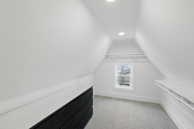 walk in closet featuring lofted ceiling and light carpet