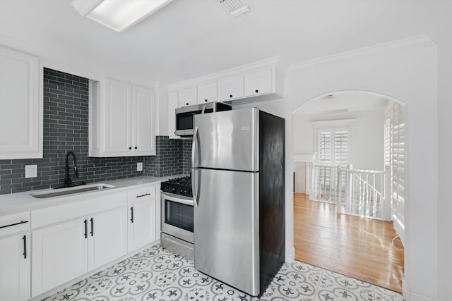 kitchen with visible vents, light countertops, stainless steel appliances, white cabinetry, and a sink