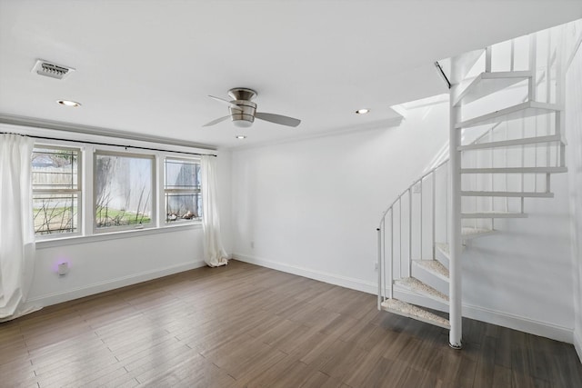 interior space featuring visible vents, baseboards, wood finished floors, and stairway