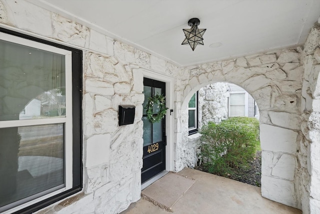 view of exterior entry featuring stone siding