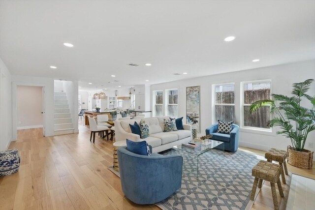 living room with recessed lighting, stairway, visible vents, and light wood-style flooring