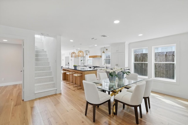 dining area featuring visible vents, recessed lighting, stairway, light wood-style floors, and baseboards