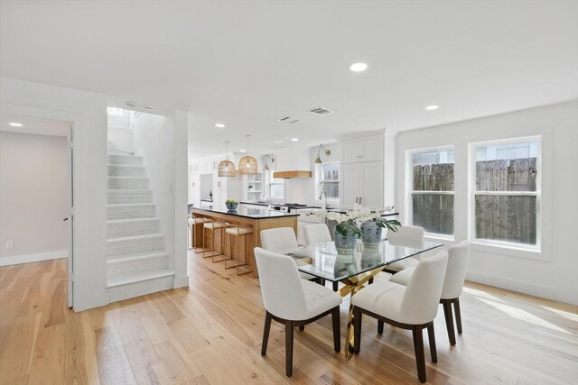 dining area featuring visible vents, recessed lighting, stairway, light wood-style floors, and baseboards