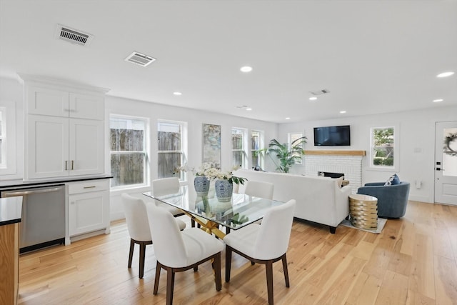 dining area with visible vents and light wood-style floors