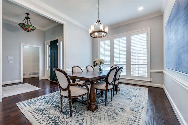 dining area with ornamental molding, visible vents, hardwood / wood-style floors, and baseboards