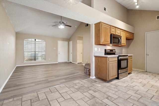 kitchen with stainless steel appliances, light countertops, visible vents, a ceiling fan, and high vaulted ceiling