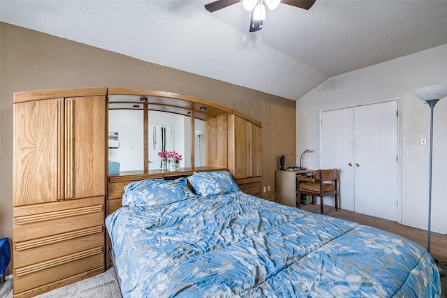 carpeted bedroom featuring vaulted ceiling, ceiling fan, a textured ceiling, and a closet